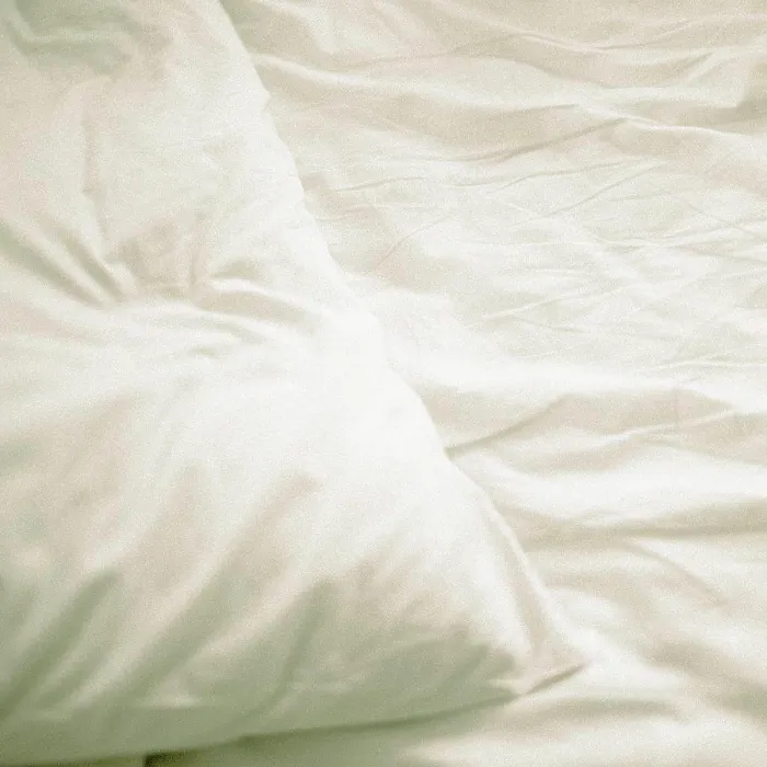 Framed Print : A pillow on a bed