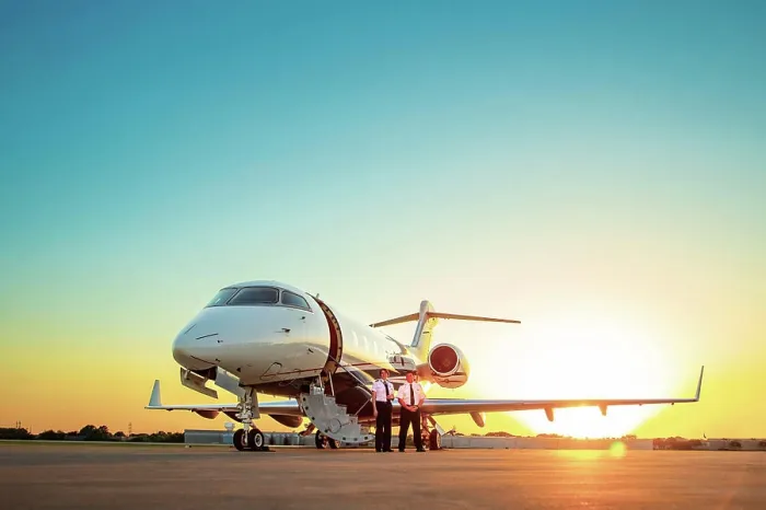 Framed Print : Two Pilots standing next to Jet on tarmac of small airport at sunset Framed Print : Two Pilots standing next to Jet on tarmac of small airport at sunset