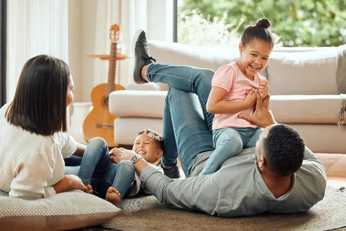 Framed Print : Playing, parents and children relax in living room for bonding Framed Print : Playing, parents and children relax in living room for bonding