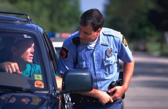 Framed Print : Police officer approaches the driver of a car after stopping him for a traffic violation Framed Print : Police officer approaches the driver of a car after stopping him for a traffic violation