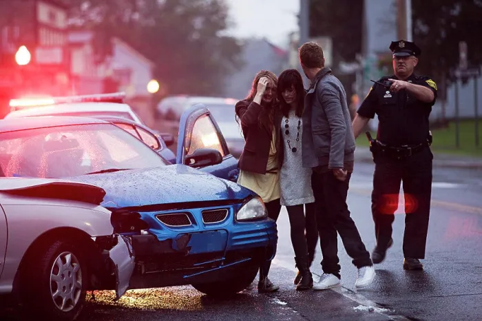 Framed Print : Police officer on scene of automobile accident escorting three injured young adults to safety Framed Print : Police officer on scene of automobile accident escorting three injured young adults to safety