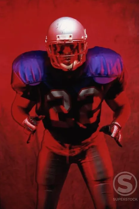 Framed Print : Portrait of an American football player standing in a tackle pose Framed Print : Portrait of an American football player standing in a tackle pose