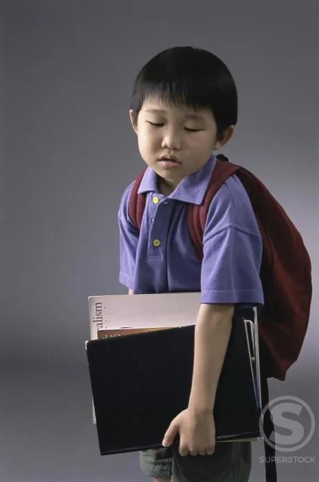 Framed Print : Portrait of a boy carrying book and a backpack Framed Print : Portrait of a boy carrying book and a backpack