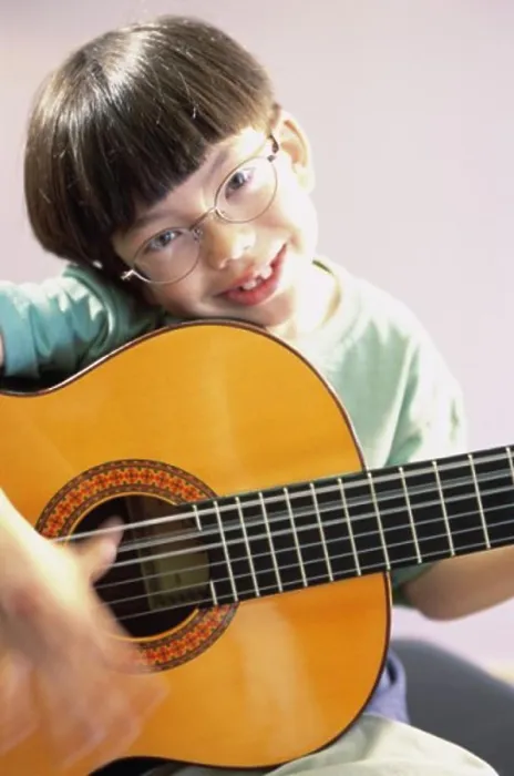 Framed Print : Portrait of a boy playing a guitar