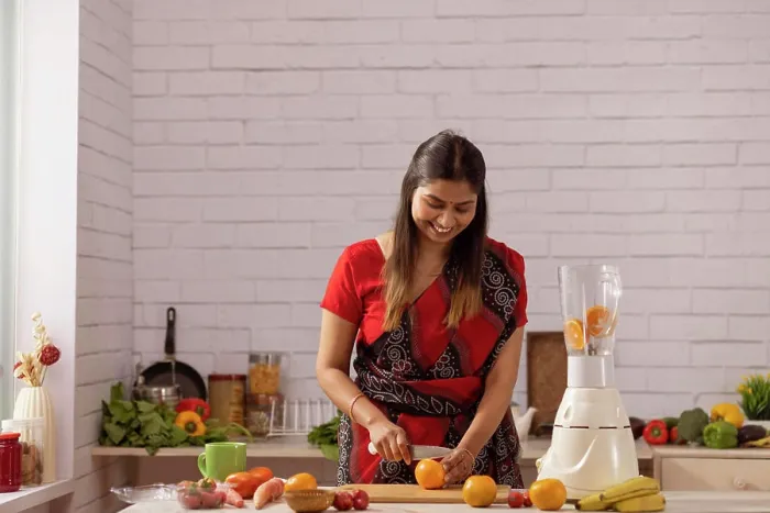 Framed Print : Portrait of cheerful woman chopping fresh fruit in kitchen Framed Print : Portrait of cheerful woman chopping fresh fruit in kitchen