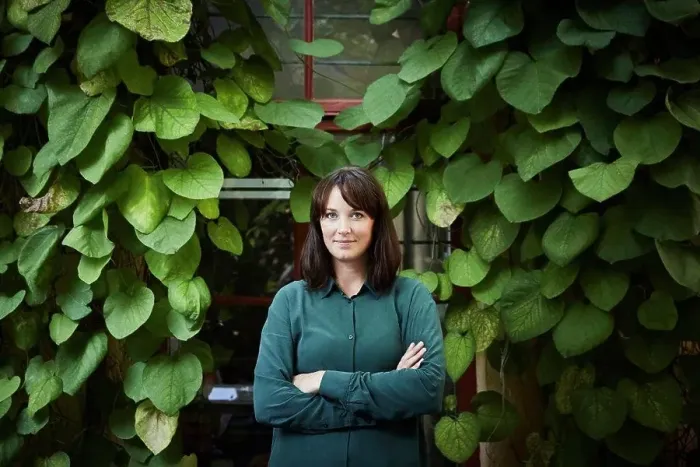 Framed Print : Portrait of confident female architect standing against creeper plants in backyard Framed Print : Portrait of confident female architect standing against creeper plants in backyard