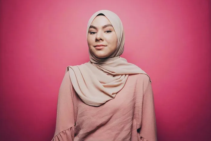 Framed Print : Portrait of confident young woman wearing hijab against pink background Framed Print : Portrait of confident young woman wearing hijab against pink background