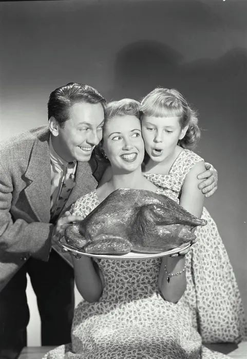 Framed Print : Portrait of a family holding a turkey on a platter