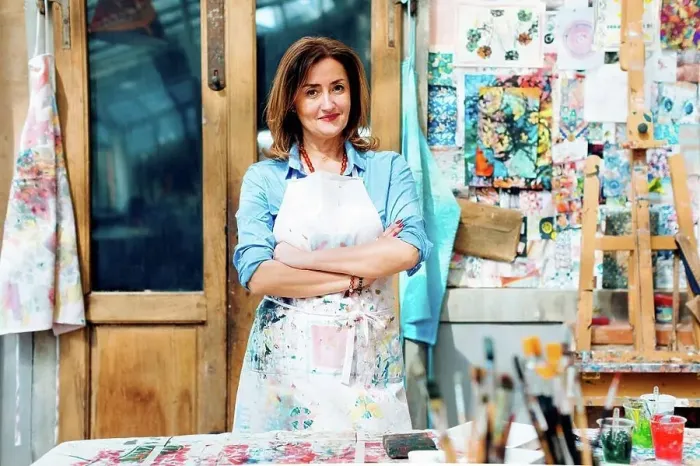 Framed Print : Portrait of female artist in creative studio, smiling Framed Print : Portrait of female artist in creative studio, smiling
