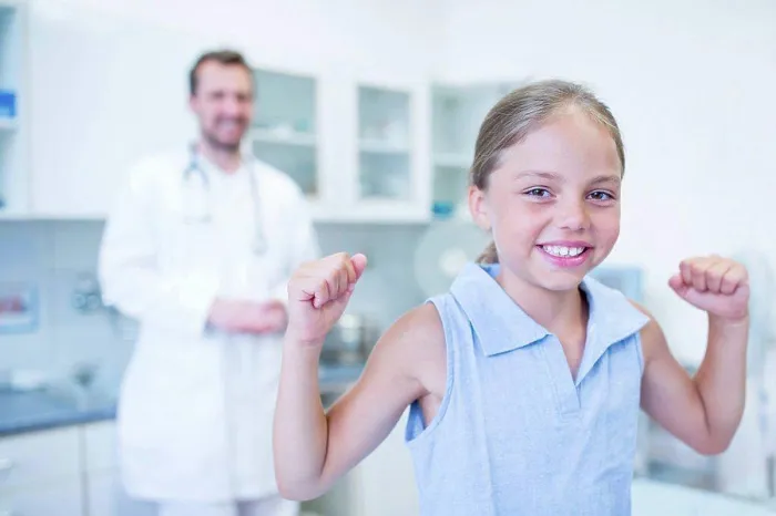 Framed Print : Portrait of girl cheering in doctor's surgery