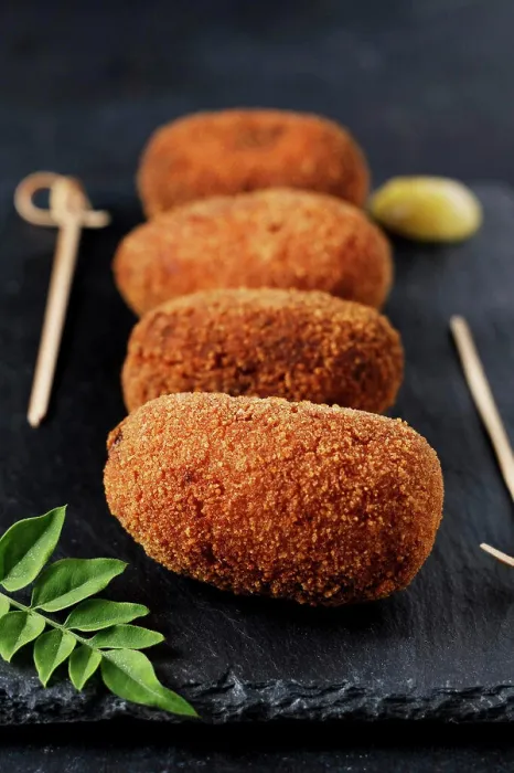 Framed Print : Portrait of gourmet style ham croquettes with black background Framed Print : Portrait of gourmet style ham croquettes with black background