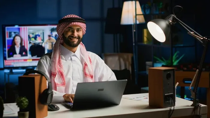 Framed Print : Portrait of happy Arab freelancer solving tasks while working from home Framed Print : Portrait of happy Arab freelancer solving tasks while working from home