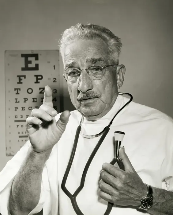 Framed Print : Portrait of a male doctor holding a stethoscope Framed Print : Portrait of a male doctor holding a stethoscope