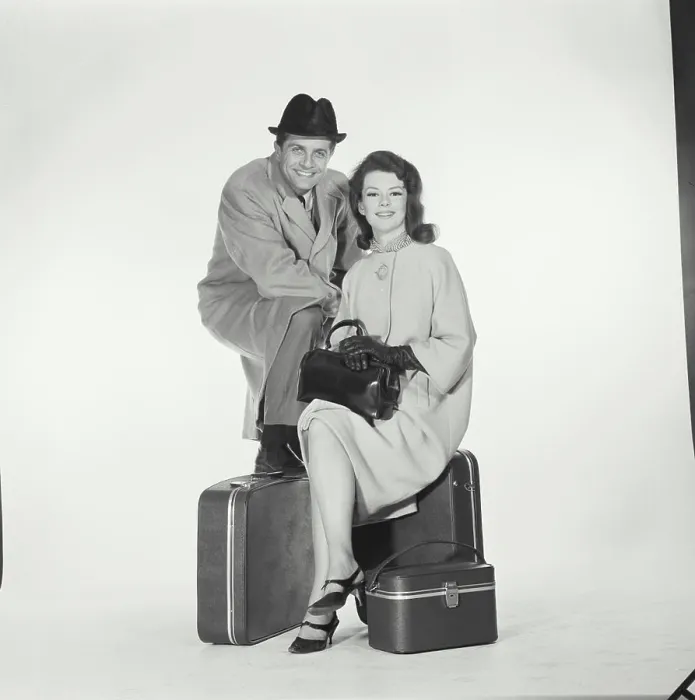 Framed Print : Portrait of a mid adult couple sitting with luggage Framed Print : Portrait of a mid adult couple sitting with luggage