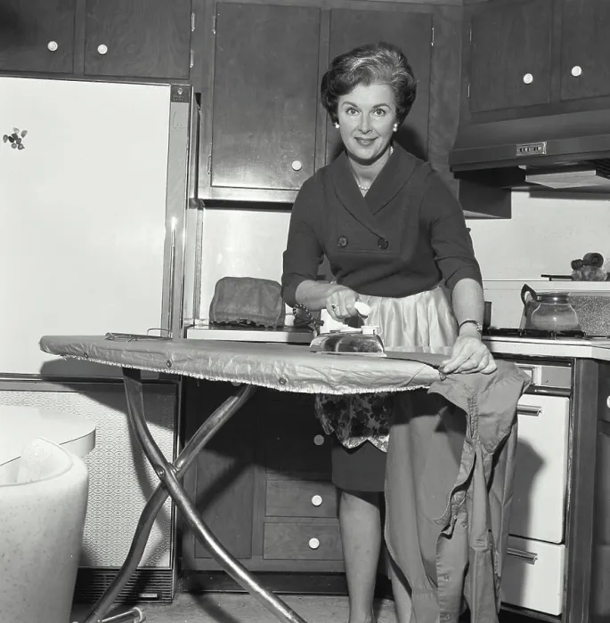 Framed Print : Portrait of a mid adult woman ironing clothes Framed Print : Portrait of a mid adult woman ironing clothes