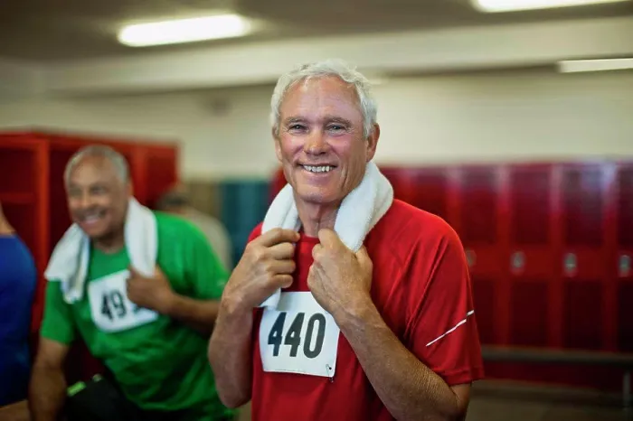 Framed Print : Portrait of a smiling senior man in a locker room