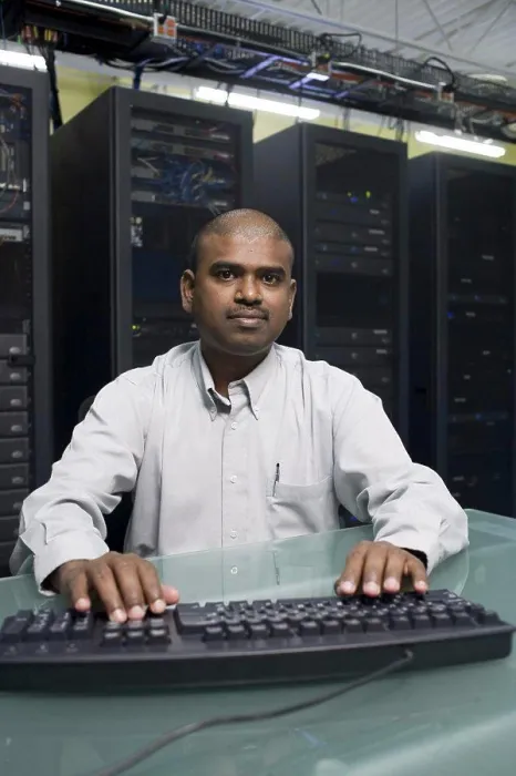 Framed Print : Portrait of a technician working on a network server Framed Print : Portrait of a technician working on a network server