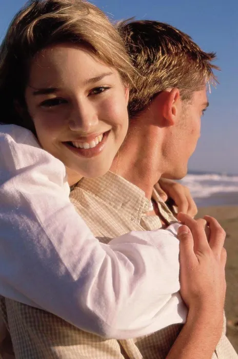 Framed Print : Portrait of a teenage girl hugging a young man Framed Print : Portrait of a teenage girl hugging a young man