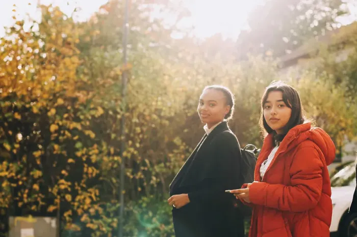 Framed Print : Portrait of teenage girls in jacket against trees during autumn Framed Print : Portrait of teenage girls in jacket against trees during autumn