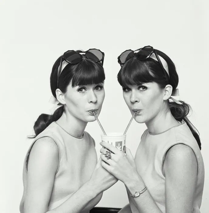 Framed Print : Portrait of twin young women drinking cold drink Framed Print : Portrait of twin young women drinking cold drink