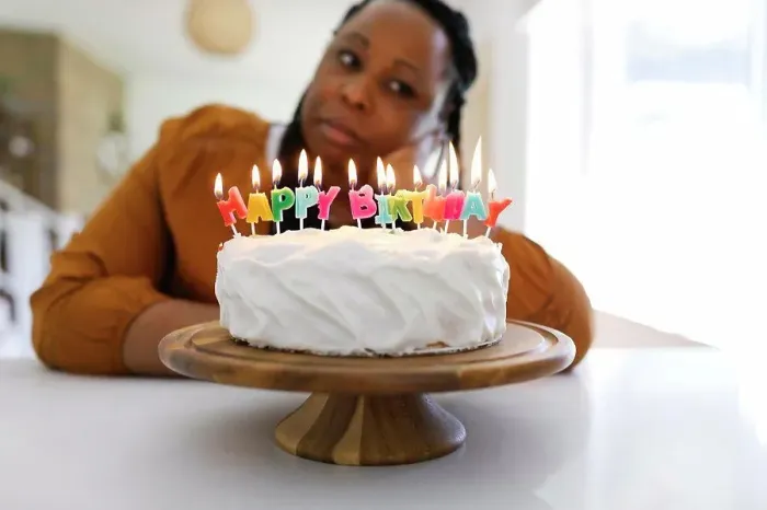 Framed Print : Portrait of woman behind birthday cake Framed Print : Portrait of woman behind birthday cake