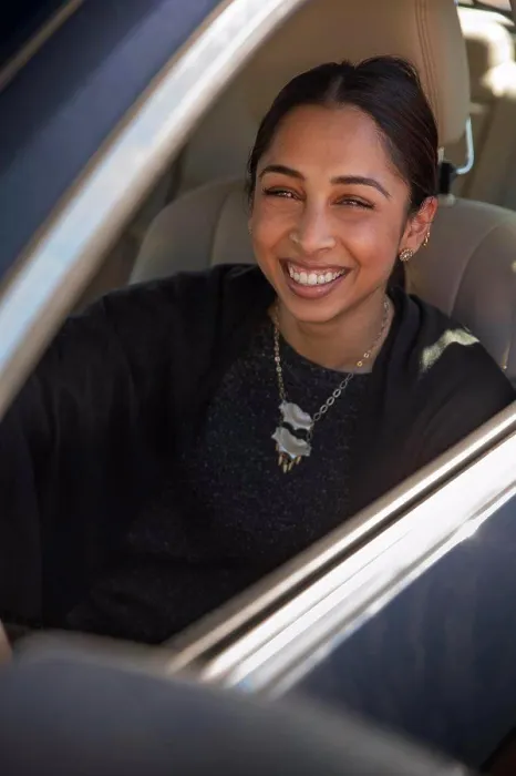Framed Print : Portrait of woman sitting in drivers seat of car with window open, laughing and looking at camera Framed Print : Portrait of woman sitting in drivers seat of car with window open, laughing and looking at camera
