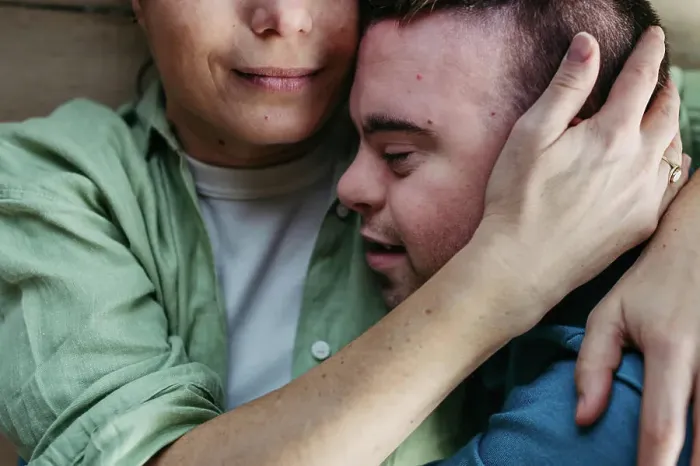 Framed Print : Portrait of young man with Down syndrome with his mother at home