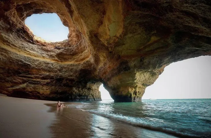 Framed Print : Portugal, beach of Benagil, cave, woman sitting at seafront Framed Print : Portugal, beach of Benagil, cave, woman sitting at seafront