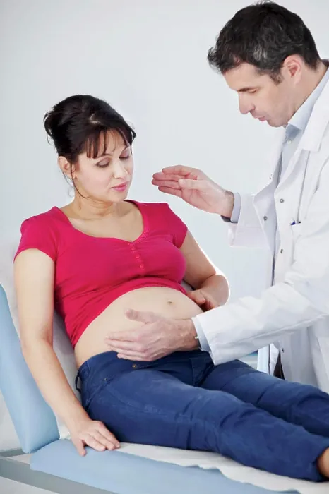 Framed Print : Pregnant woman in consultation