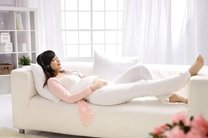 Framed Print : Pregnant woman listening to music Framed Print : Pregnant woman listening to music