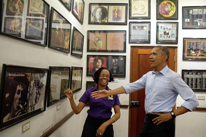 Framed Print : President Barack Obama looks at memorabilia with museum guide Natasha Clark at the Bob Marley Museum in Kingston