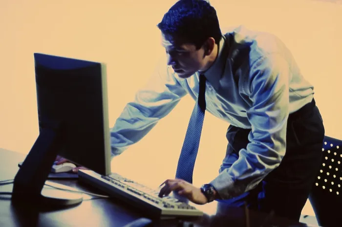 Framed Print : Side profile of a businessman using a computer Framed Print : Side profile of a businessman using a computer