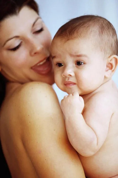Framed Print : Side profile of a mother holding her baby boy in her arms Framed Print : Side profile of a mother holding her baby boy in her arms