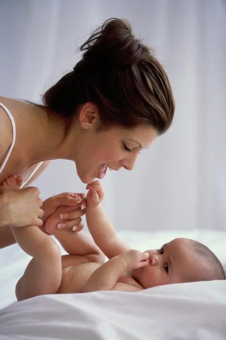 Framed Print : Side profile of a mother playing with her baby boy Framed Print : Side profile of a mother playing with her baby boy