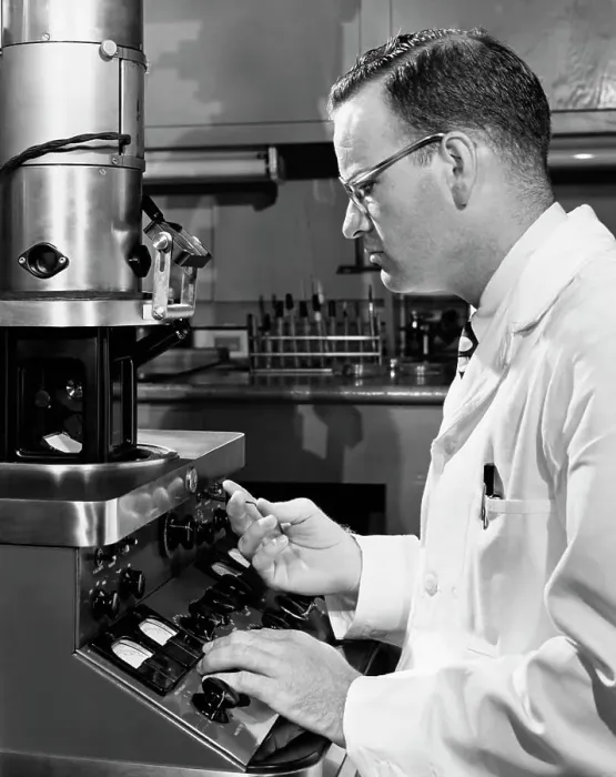 Framed Print : Side profile of a scientist working on an electron microscope Framed Print : Side profile of a scientist working on an electron microscope
