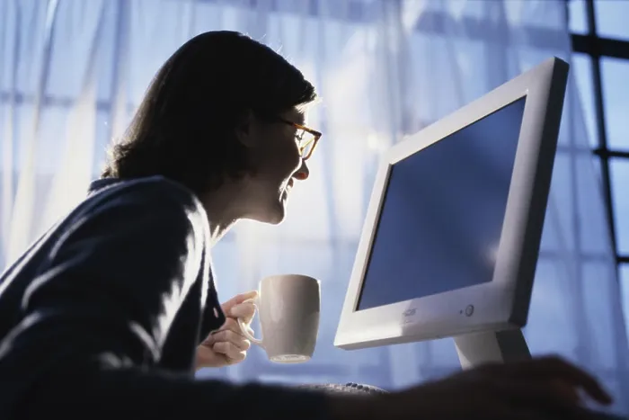 Framed Print : Side profile of a young woman using a computer