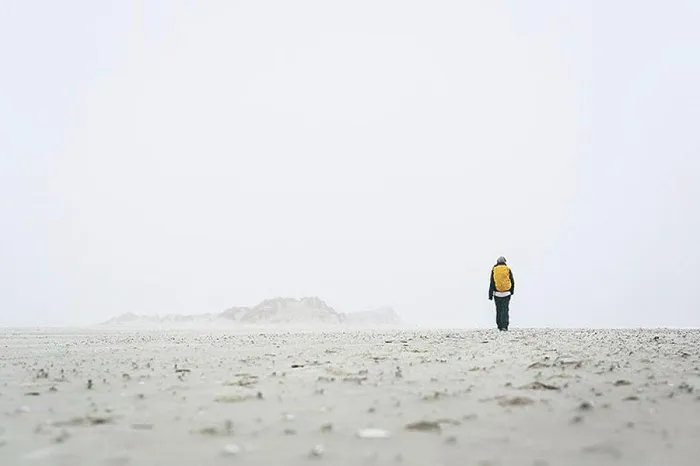 Framed Print : Rear view of female hiker walking on field against sky in foggy weather Framed Print : Rear view of female hiker walking on field against sky in foggy weather