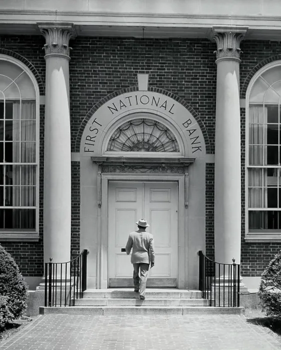 Framed Print : Rear view of a man entering a bank Framed Print : Rear view of a man entering a bank