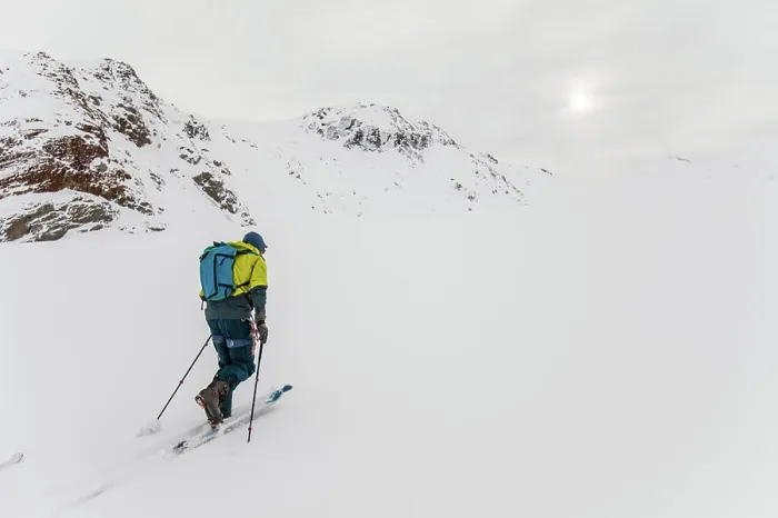 Framed Print : Rear view of man ski touring up glacier in B.C. Canada