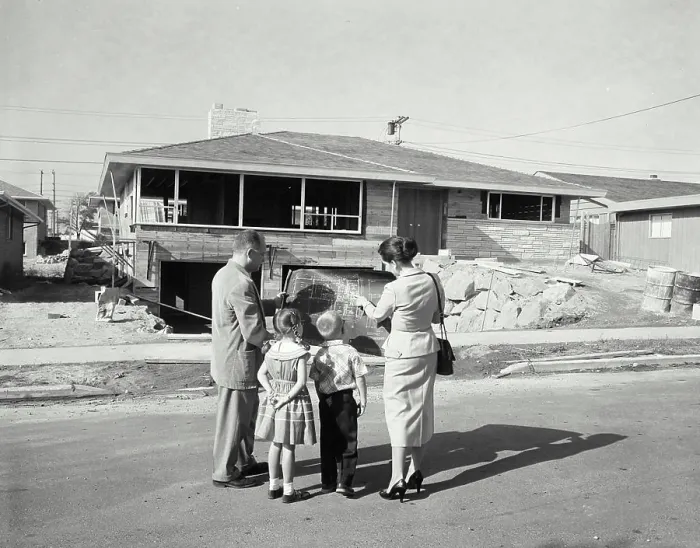 Framed Print : Rear view of a mature couple and their children standing in front of a house and looking at a blueprint Framed Print : Rear view of a mature couple and their children standing in front of a house and looking at a blueprint