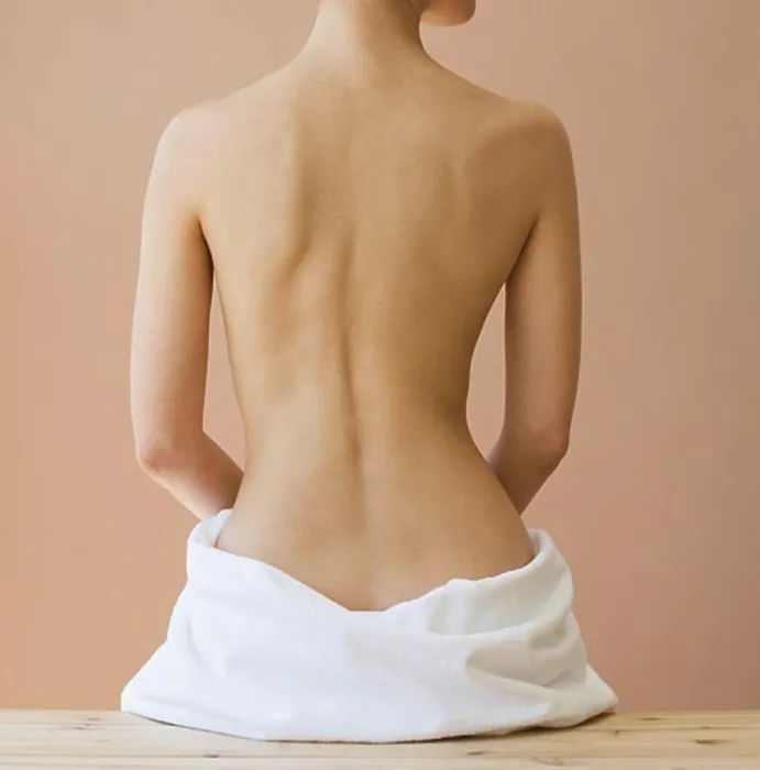 Framed Print : Rear view of nude woman with towel around hips Framed Print : Rear view of nude woman with towel around hips
