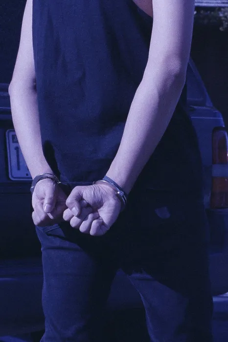 Framed Print : Rear view of a person in handcuffs Framed Print : Rear view of a person in handcuffs