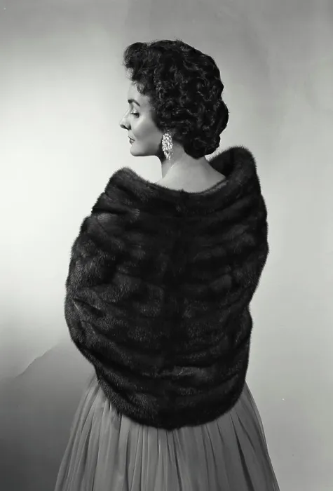Framed Print : Rear view of a young woman wearing a fur shawl Framed Print : Rear view of a young woman wearing a fur shawl
