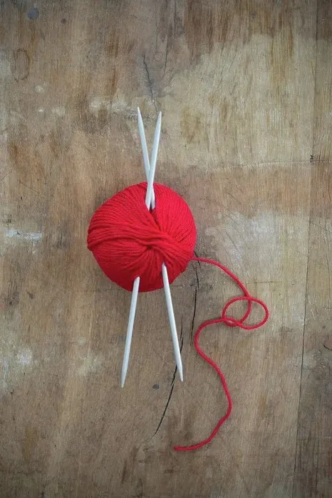 Framed Print : Red ball of wool and knitting needles on wood