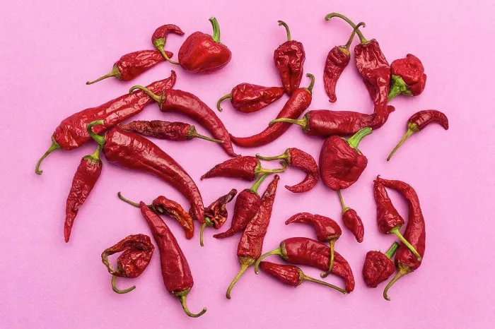 Framed Print : Red chili peppers on bright pink background Framed Print : Red chili peppers on bright pink background