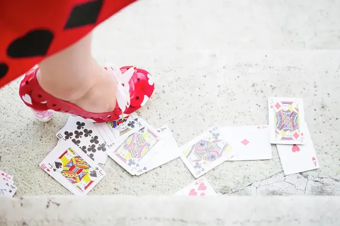 Framed Print : Red high heel standing on the playing card