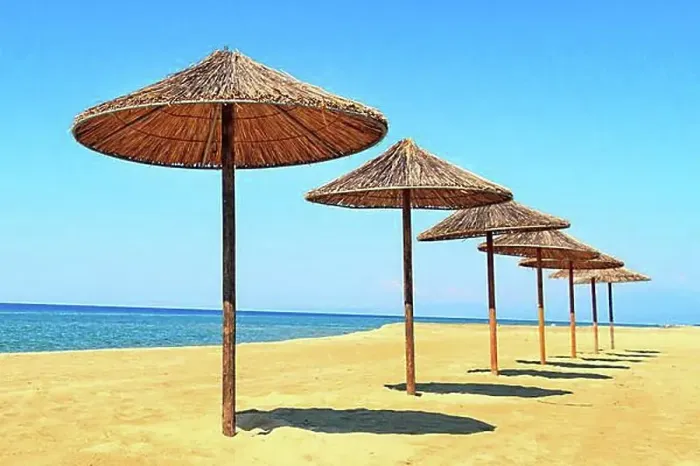 Framed Print : Row of wooden umbrellas at sandy beach, sea and blue sky vacation background, Greece, Europe Framed Print : Row of wooden umbrellas at sandy beach, sea and blue sky vacation background, Greece, Europe