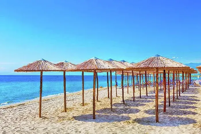 Framed Print : Row of wooden umbrellas at sandy beach, sea and blue sky vacation background, Greece, Europe Framed Print : Row of wooden umbrellas at sandy beach, sea and blue sky vacation background, Greece, Europe
