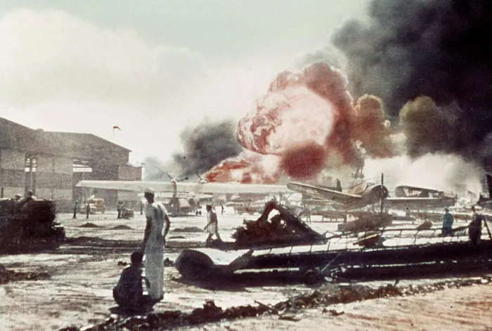 Framed Print : Sailors surrounded by wrecked planes at the Ford Island Naval Air Station watch as the USS Shaw explodes Pearl Harbor