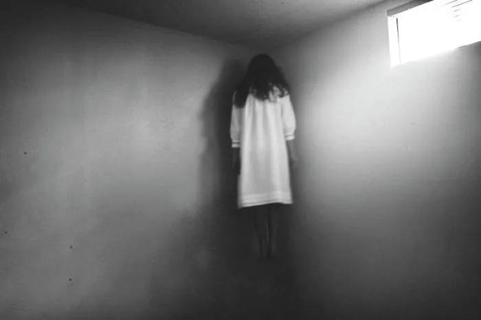 Framed Print : Scary girl in nightgown hovering in the corner of room Framed Print : Scary girl in nightgown hovering in the corner of room